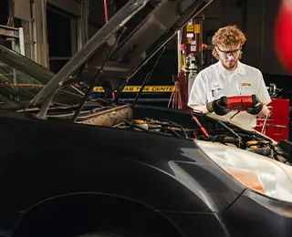 Les Schwab technician testinga battery