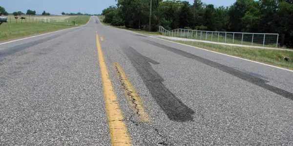 Tire burnout marks on a country road