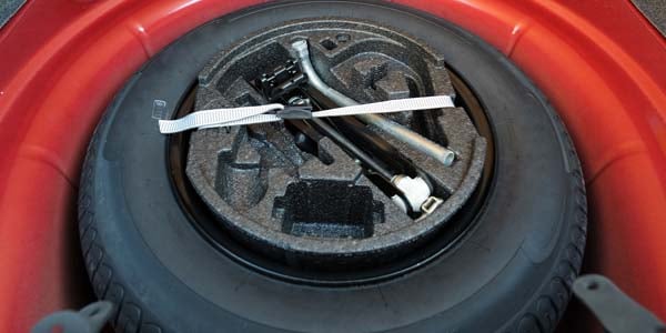 A spare tire in a car trunk.