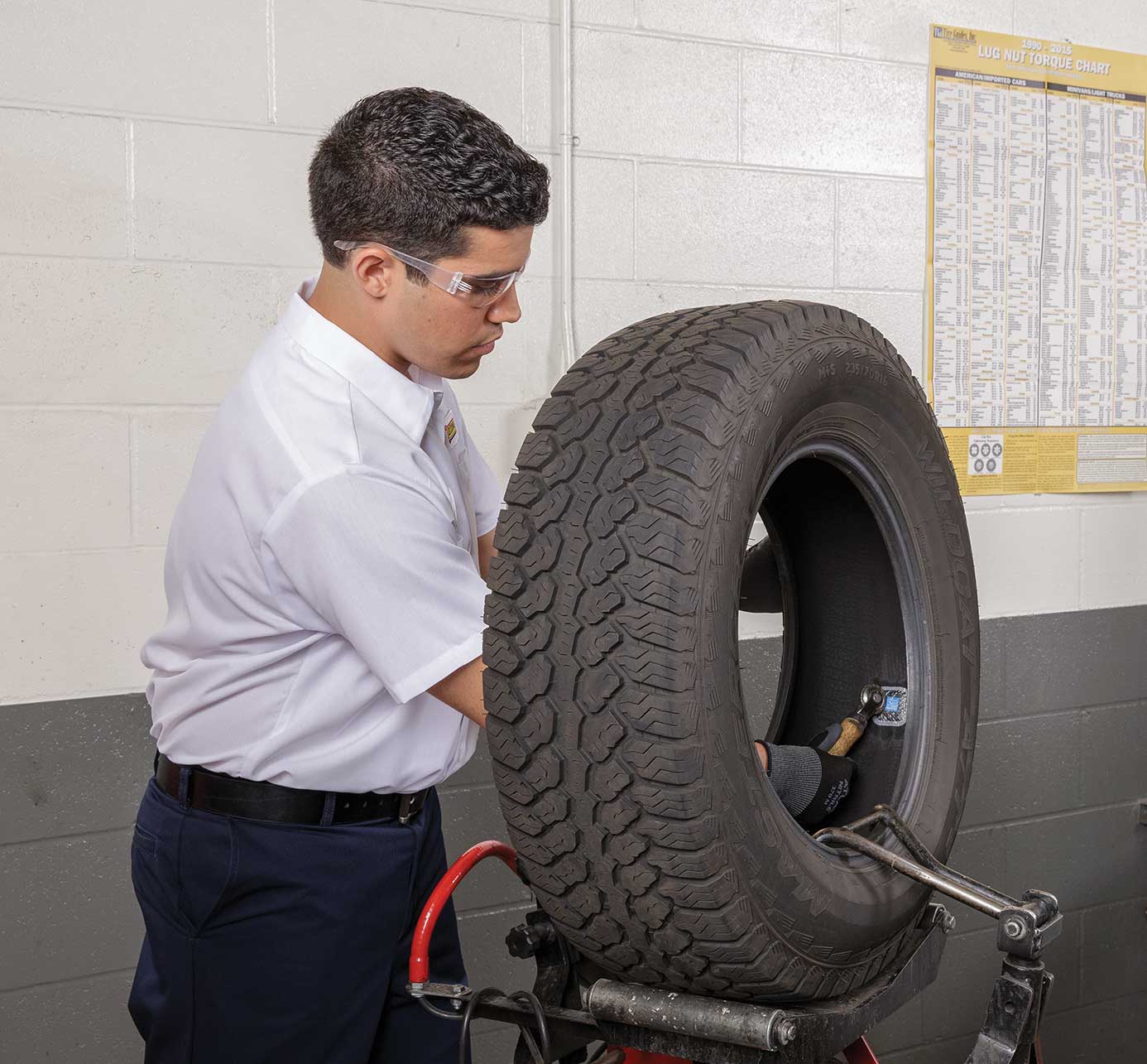 Les Schwab Tires tech doing warranty flat repair