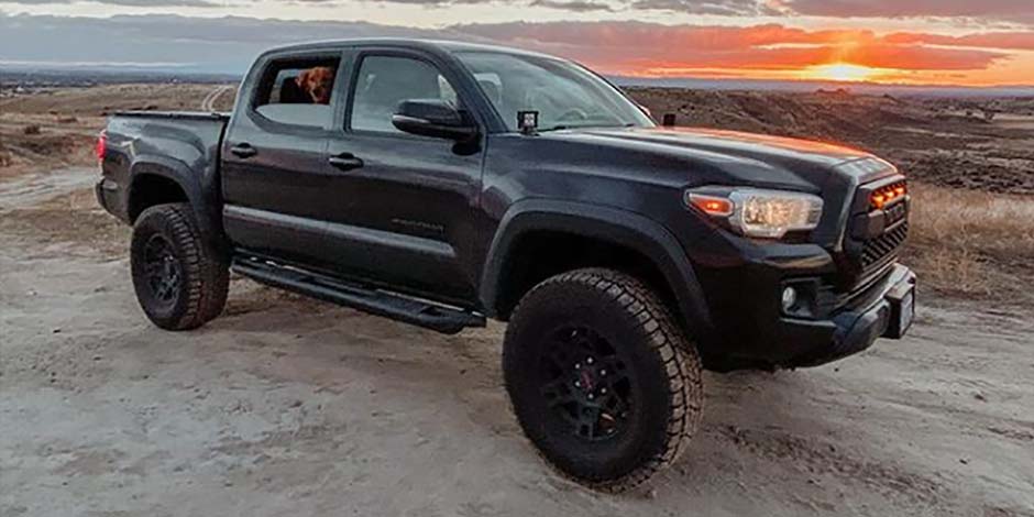 Black pickup at sunset