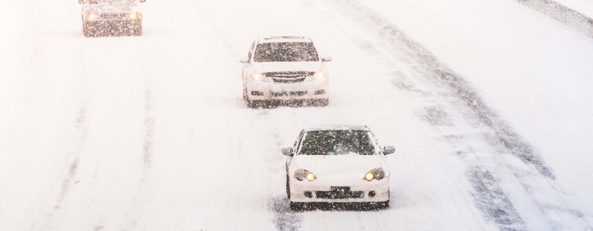 Vehicles on a snowy freeway.