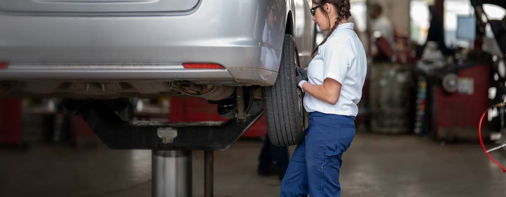 Les Schwab technician rotating car tires