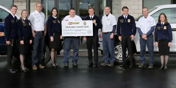 Les Schwab employees and Oregon FFA members standing in front of a Les Schwab store. 