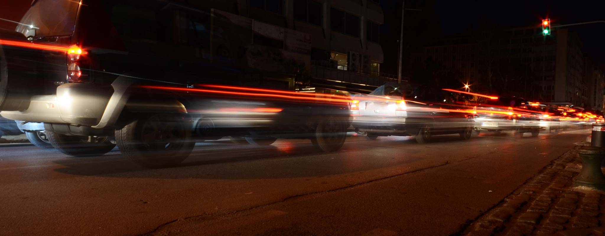 Brake lights shining on a busy city street.