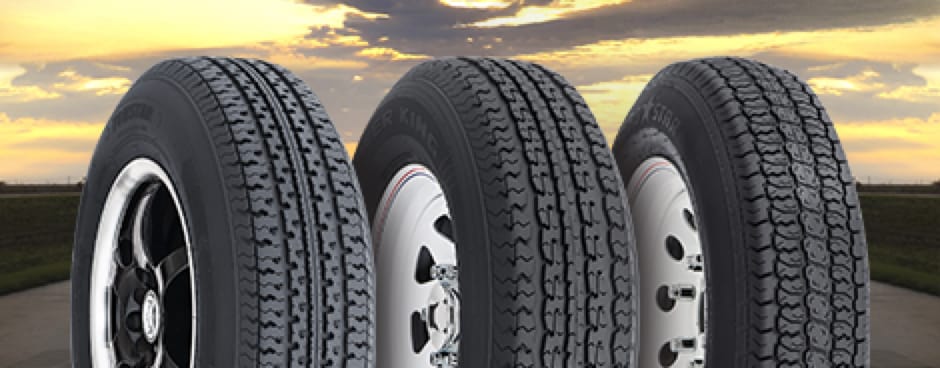 Three different tires lined up against a backdrop of a beautiful cloudy sky.