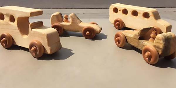 A set of hand carved wood cars.