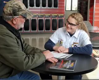 Les Schwab employee discussing options with customer