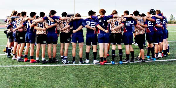 The Great Oak high school rugby team stand united in a scrum.