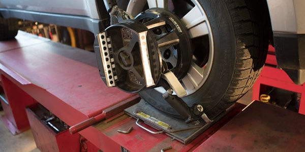 Wheel alignment tool mounted on a front tire.