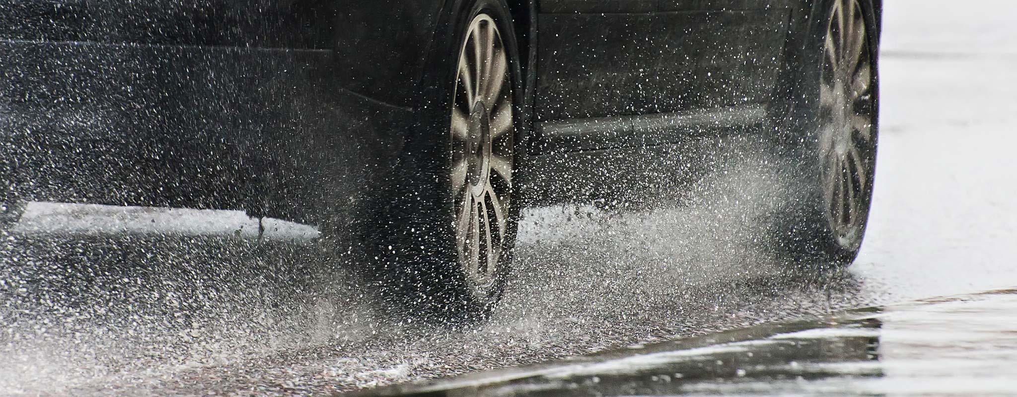 Car driving on wet road.