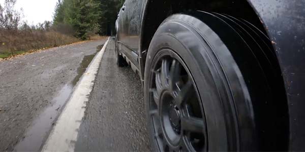 Up close of car tire on wet road
