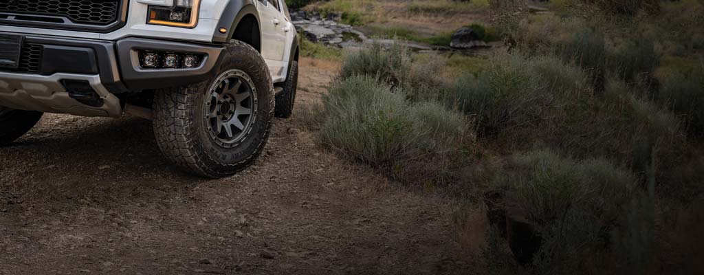 White pickup on gravel road