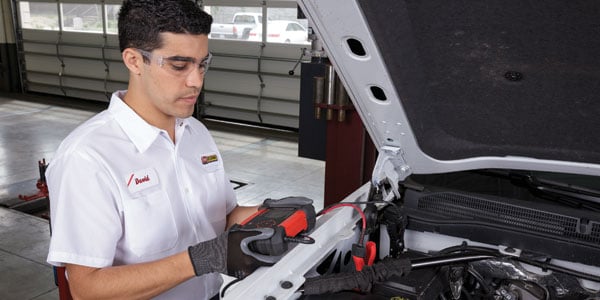 Les Schwab Tire Centers technician checking battery charge