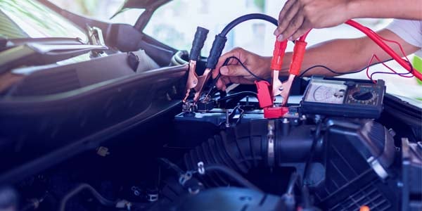 Car battery with jumper cables installed