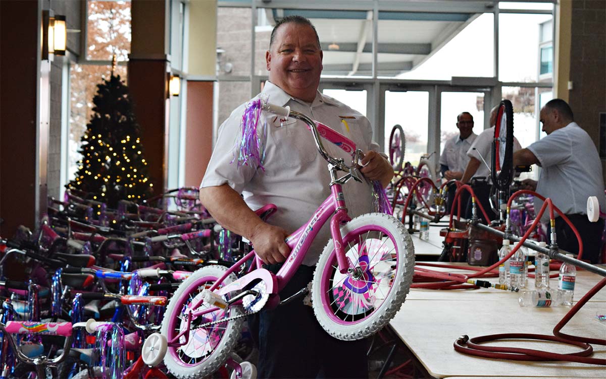 Les Schwab manager working at the bicycle assembly tables.