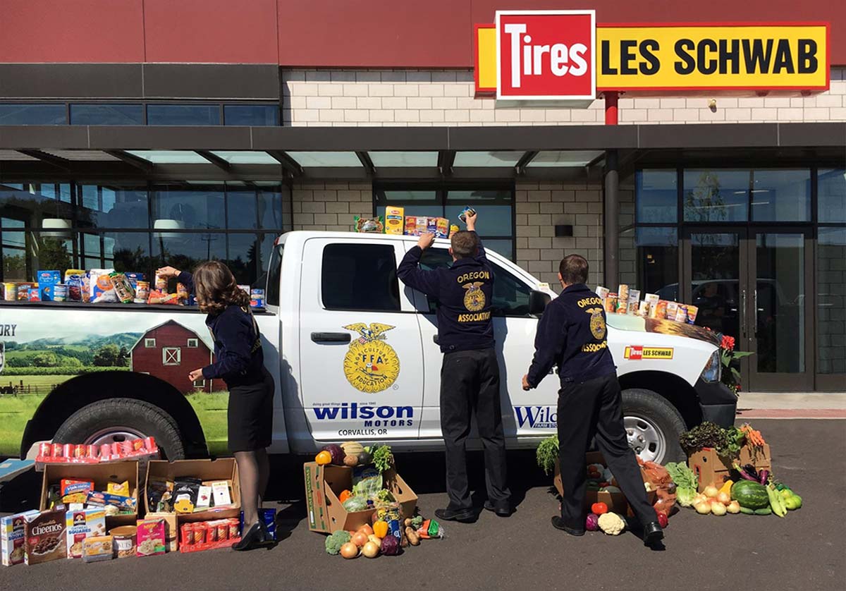 Oregon FFA Participants surround a pickup loaded with donated food