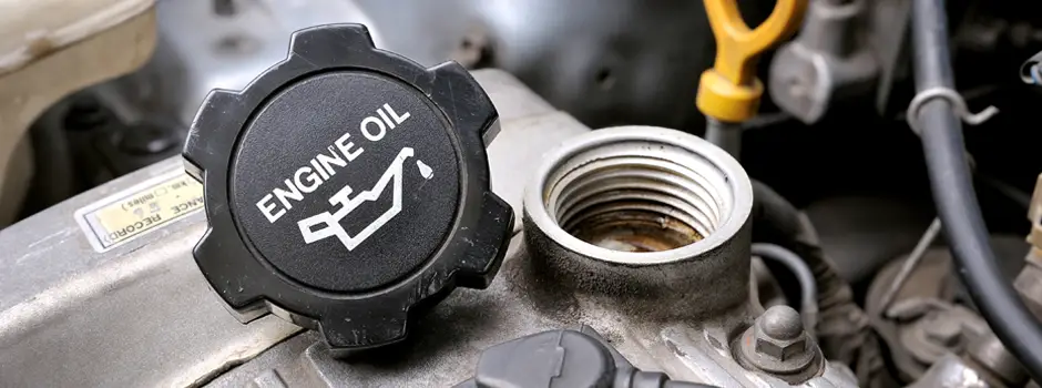 Engine oil cap off, showing where to pour oil.