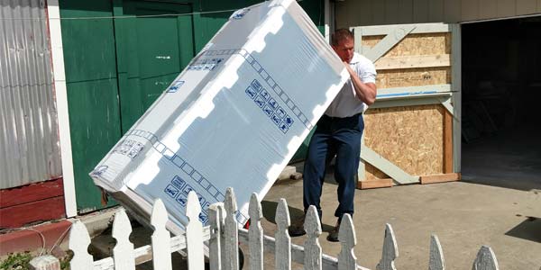 Les Schwab manager Brett Clark delivering a new fridge to the 4-H clubhouse.