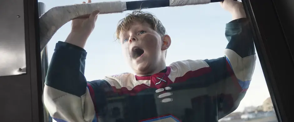 Young hockey player at a door