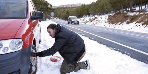 Man putting on tire chains