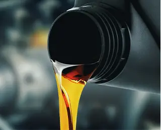 Oil being poured into a vehicle’s engine oil tank