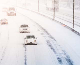 Vehicles on a snowy freeway.
