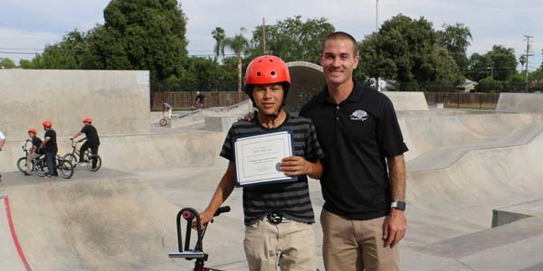 Brani Valencia and Tony Hoffman pose at a skatepark.