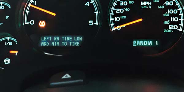 An illuminated dashboard with TPMS lights.