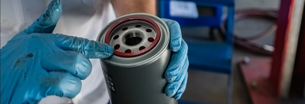 Les Schwab employee changes out the oil filter to keep a customer’s car running smooth