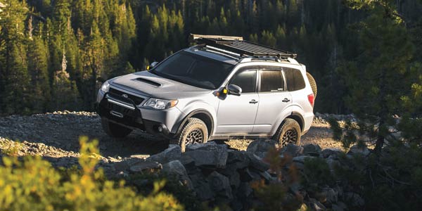 Silver Subaru Forester on a gravel mountain road