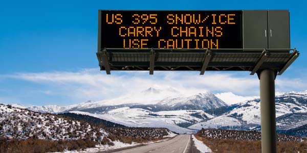 A highway sign warning of winter road conditions.