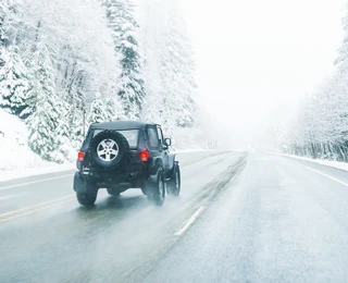 Jeep on snowy road.