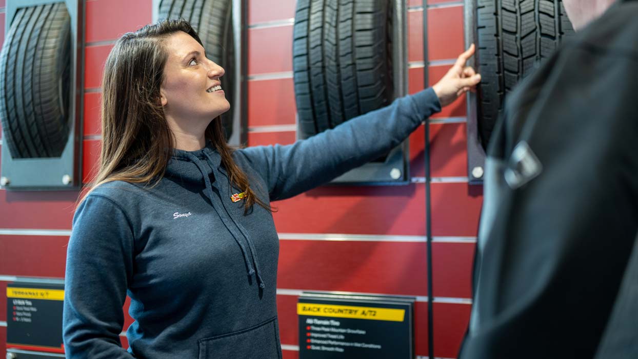 Female employee showing a customer tire options
