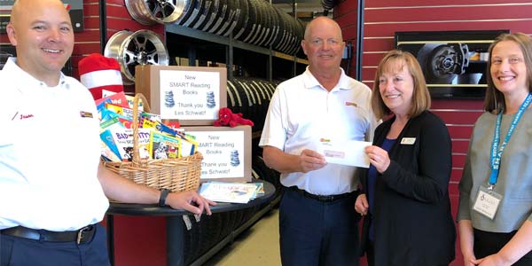 Les Schwab employees donating money that bought books for SMART in Lane County