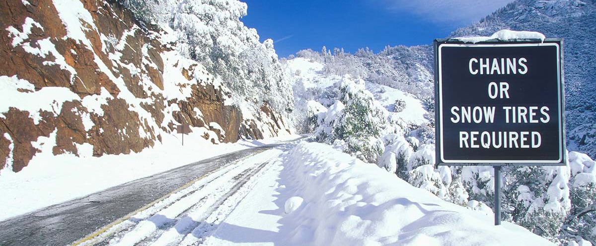 Snowy Road with chains required sign