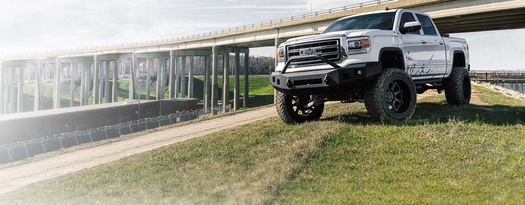 White pickup with a lift kit installed