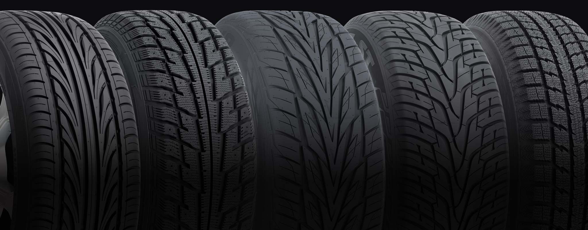 A set of directional tires with different tread designs lined up.