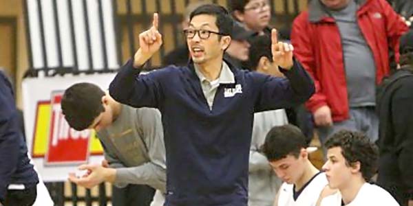 Lake Oswego basketball coach, Marshall Cho, courtside during a game.