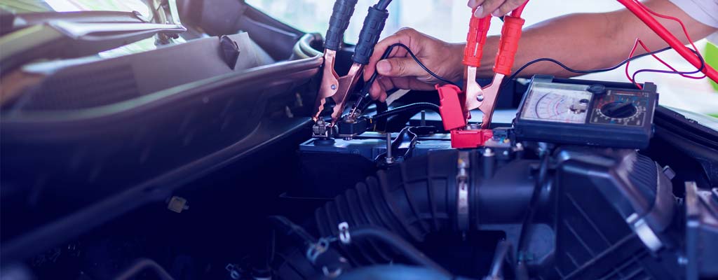 Car battery with jumper cables installed