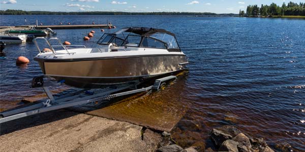 Aluminum motor boat on a trailer at a boat launch