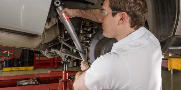 Technician installing a new shock.