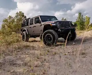 A Jeep with custom wheels and off-road tires