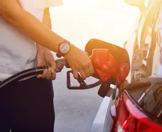 Person filling up their tank at a gas station