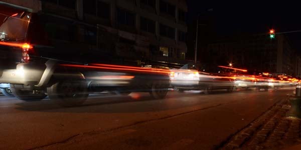 Brake lights shining on a busy city street.
