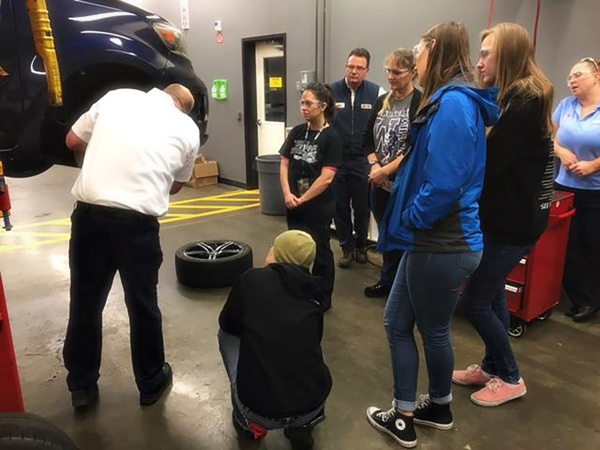 Dorian Moore and Kevin Leasure demonstrate how to change a spare tire